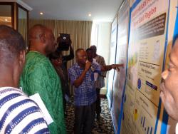Honourable Dr.  Kwaku Agyemang Mensah, Minister of Water Resources,  Works and Housing, takes a tour along the posters showing the data of the participating regions