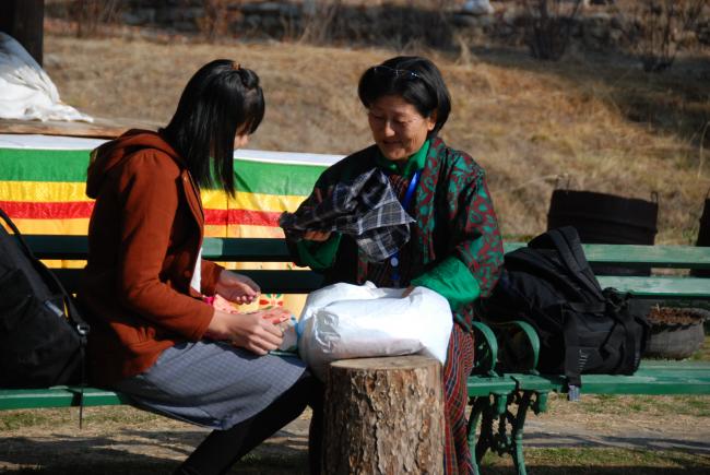 Ms Deki Tshomo (right) showing reusable sanitary pads to Ms Saing Sodany, BCC advisor for SNV Cambodia, regional SSH4A learning and sharing event, March 2015