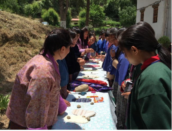 Students demonstrate how to make reuseable sanitary pads