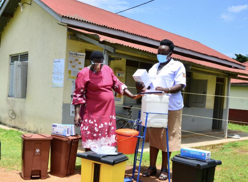 Cecilia Birungi, District Health Inspector hands over PPE