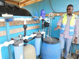 Sylvester Adjapong director of impact and quality for Access Development explains the Nexus purification system at Sekyere Aboab