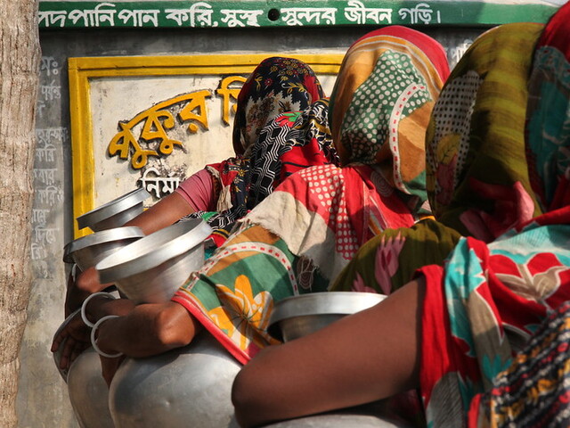 Women waiting in line for water at a pond sand filter Kharamkhali village, Chitalmari, Khulna, Bangl
