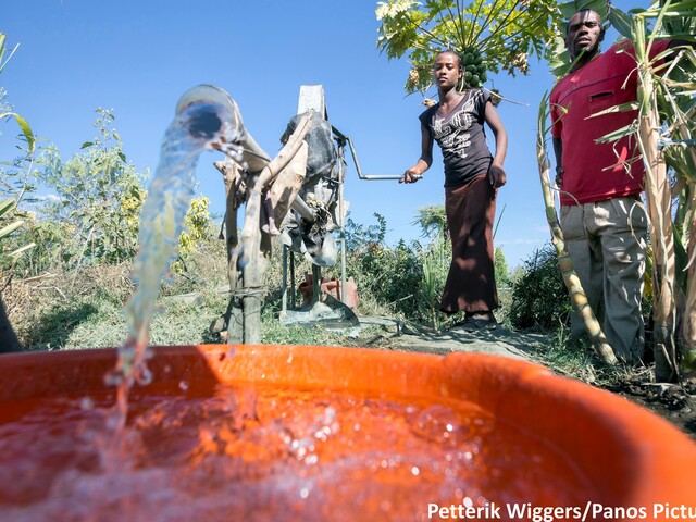 Pumping water using a family rope pump, Ethiopia.