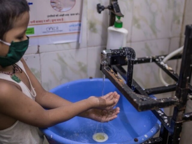 Child washing hand in India