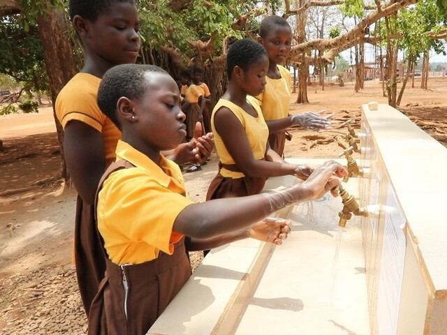 Schoolgirls washing hands