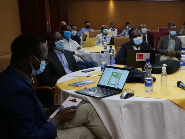 Multi-stakeholder platform meeting in Ethiopia, participant left using Telegram on his computer