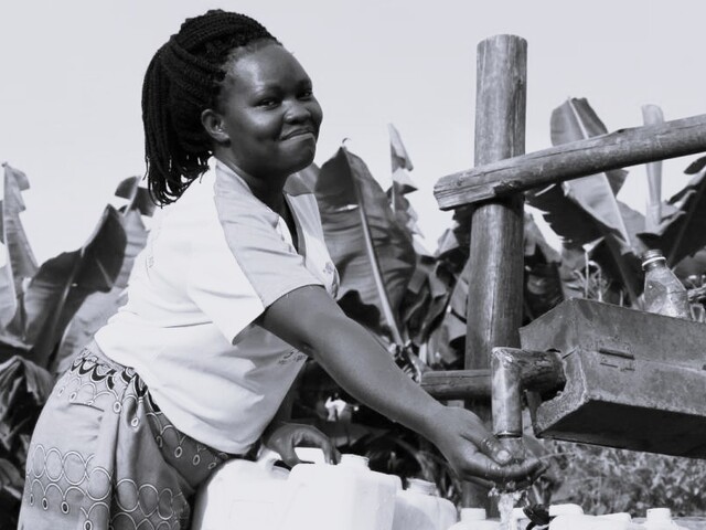 Harriet young woman in Kabarole district getting water