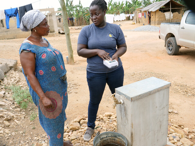 Rose Quaicoe, left, who has a household water connection at Wassa Edwenase discusses the services with Korkoe Aku Teyvi, Access 