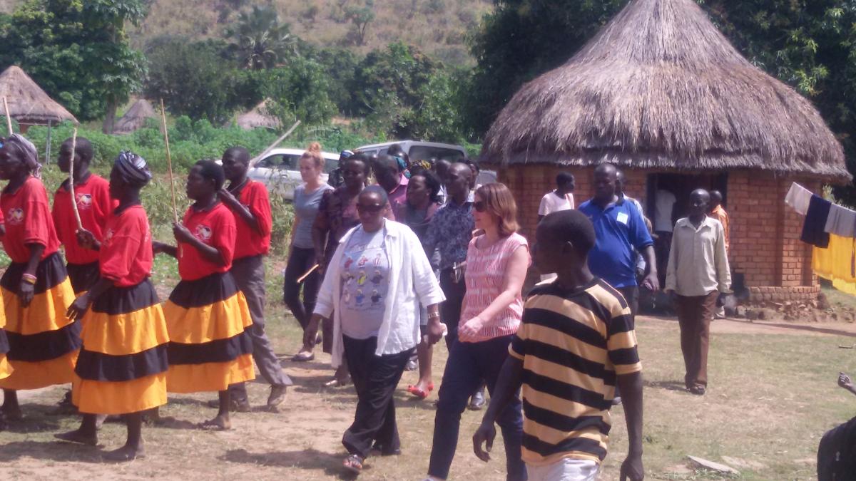 Assistant Commissioner EHD, Julian Kyomuhangi is welcomed in Iyua village